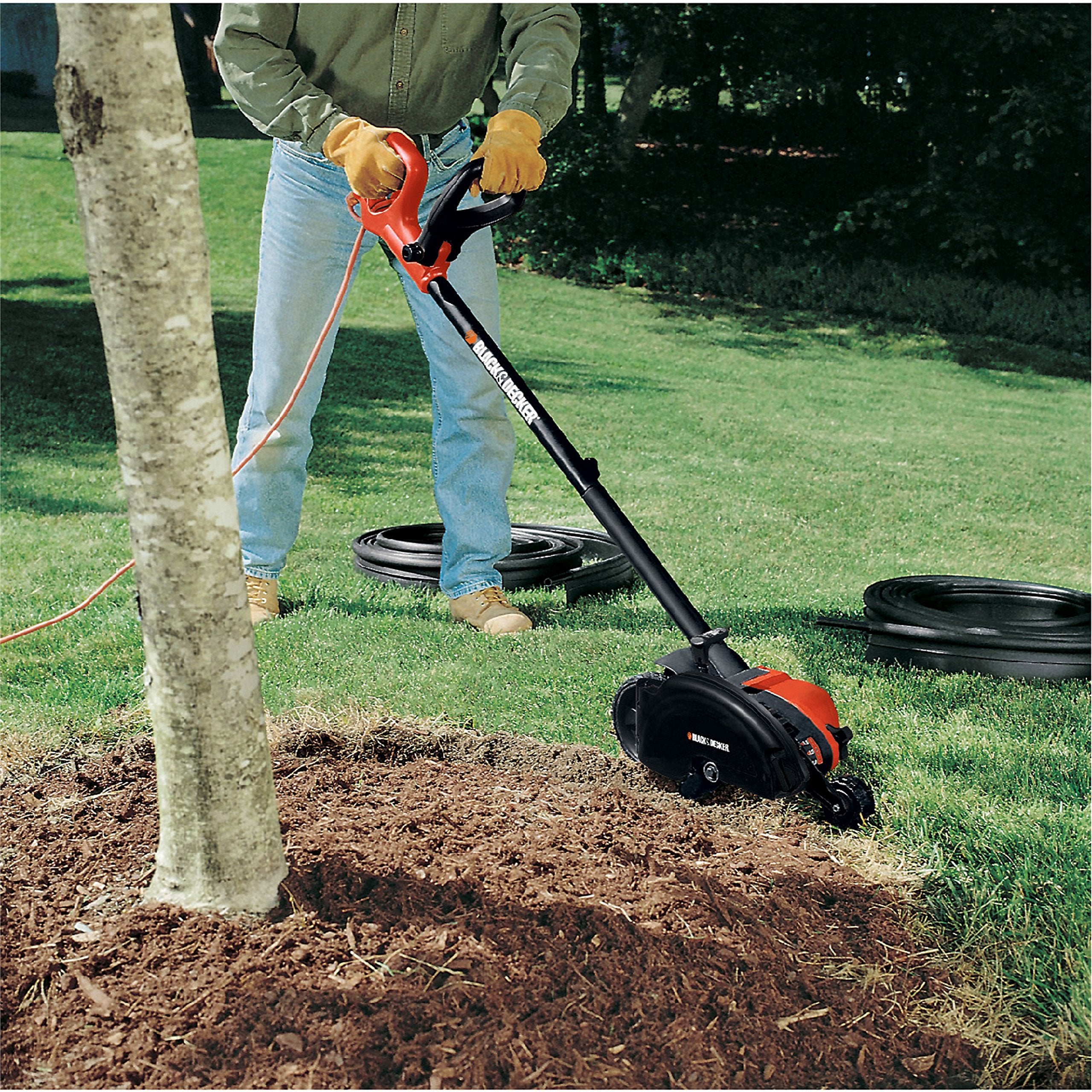 BLACK+DECKER trenching around garden bed creating narrow channel for irrigation