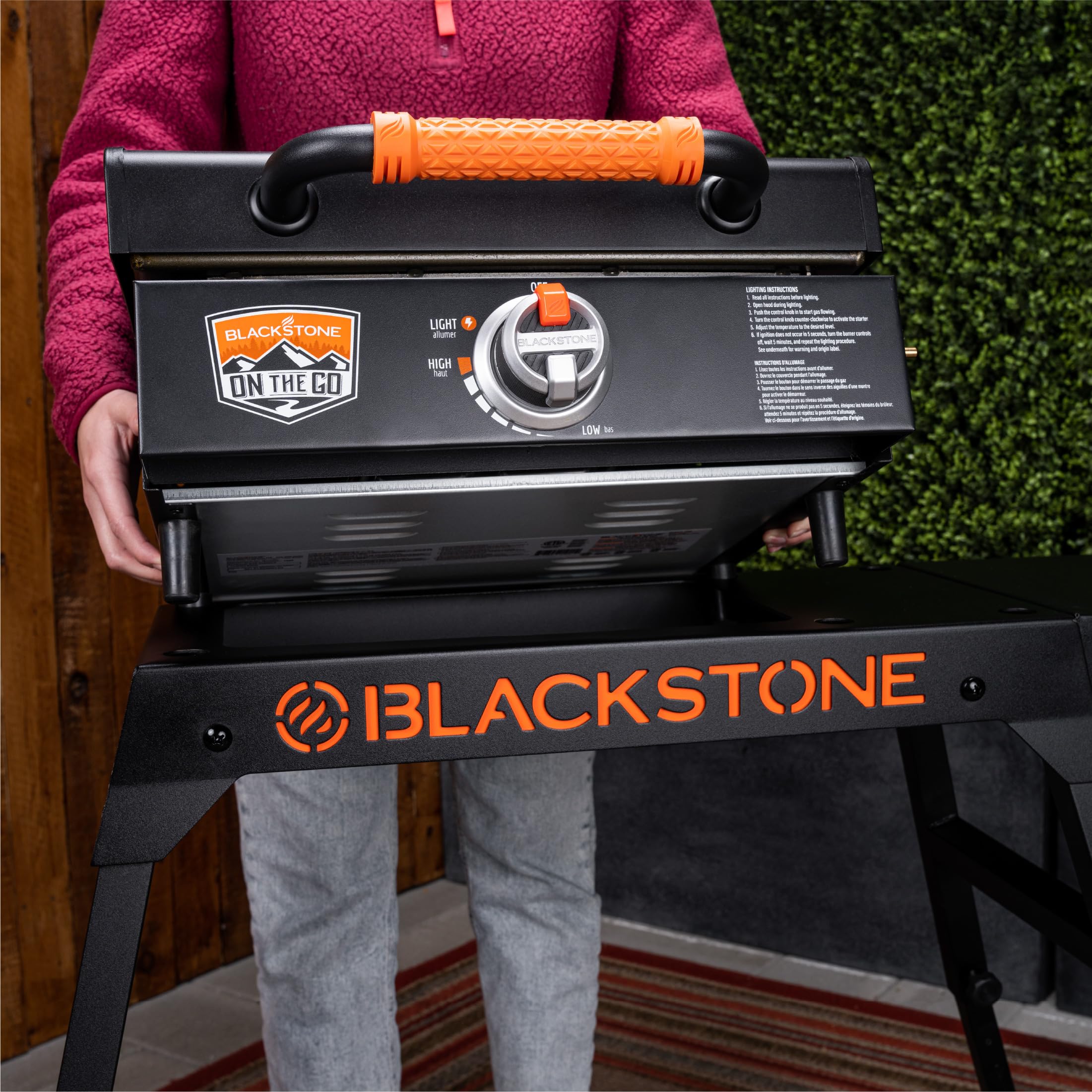 BLACKSTONE griddle on stand in use for outdoor cooking with organized workspace