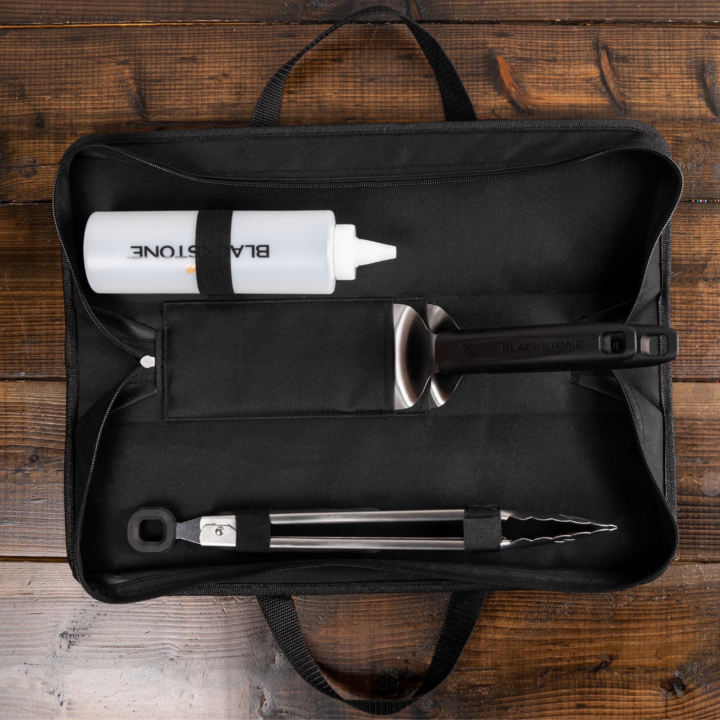 BLACKSTONE tote bag open to display organized tool pockets and secure zipper storage