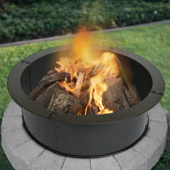 Blue Sky Outdoor Living fire ring burning in backyard evening creates warm gathering atmosphere