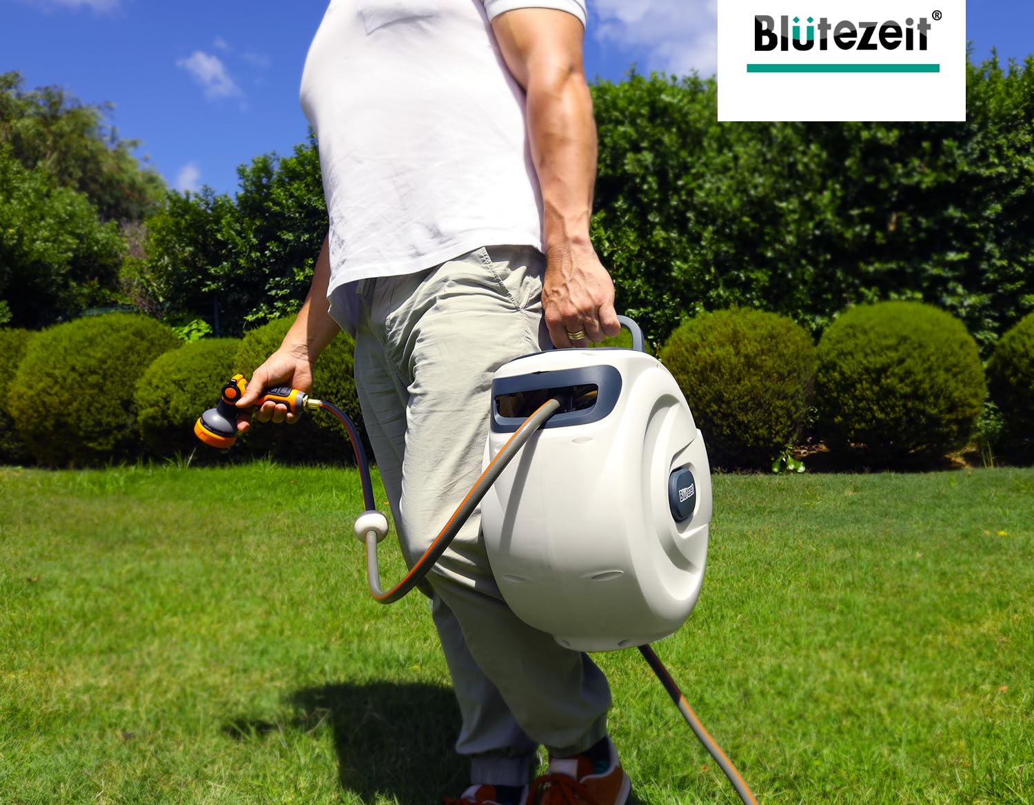 Blütezeit hose reel next to a hand for scale to show compact footprint