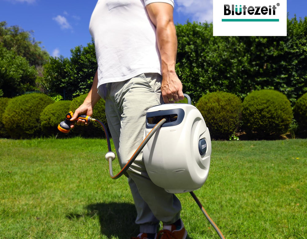 Blütezeit hose reel next to a hand for scale to show compact footprint