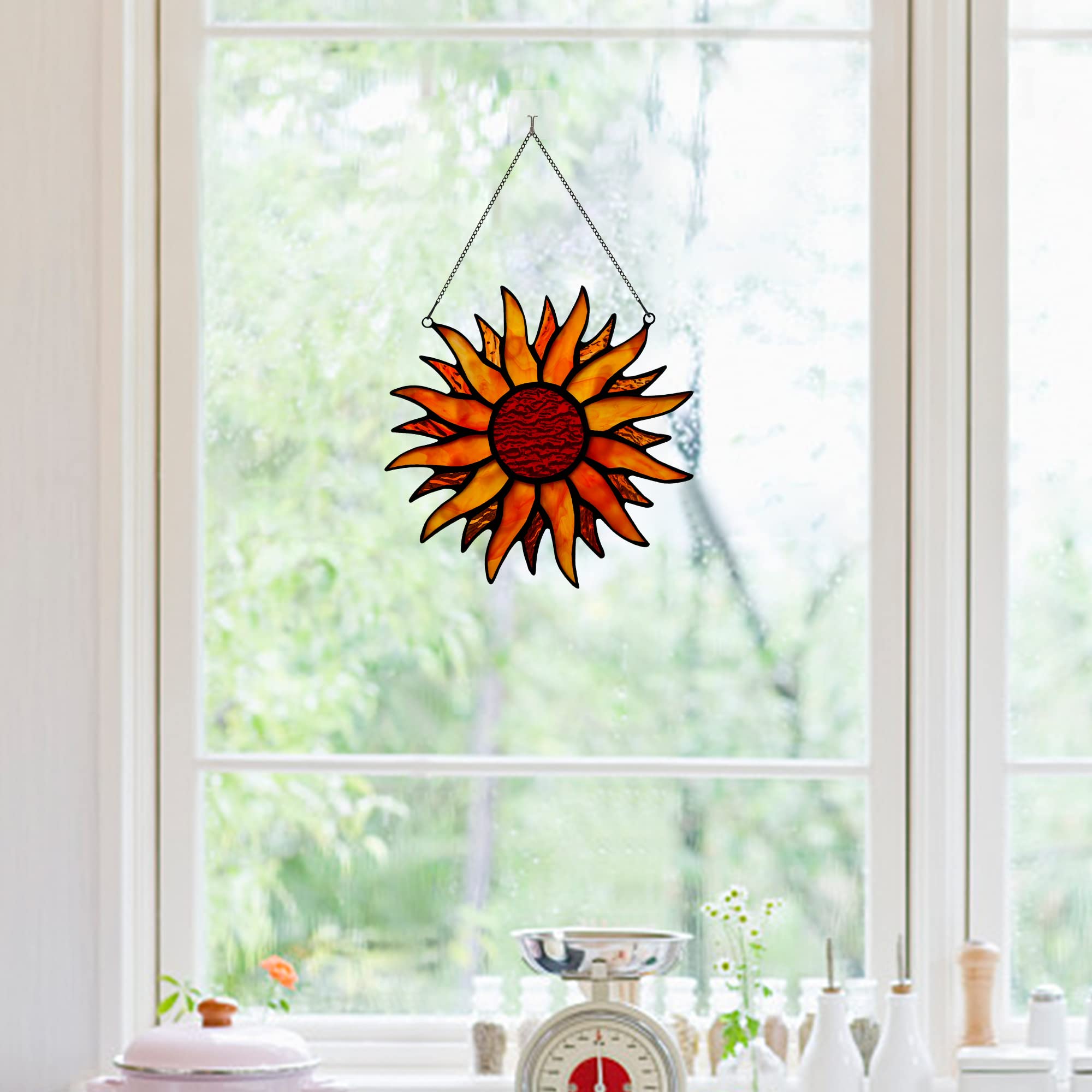BOXCASA sun suncatcher in window casting warm red and amber light across room