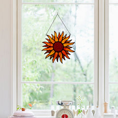 BOXCASA sun suncatcher in window casting warm red and amber light across room