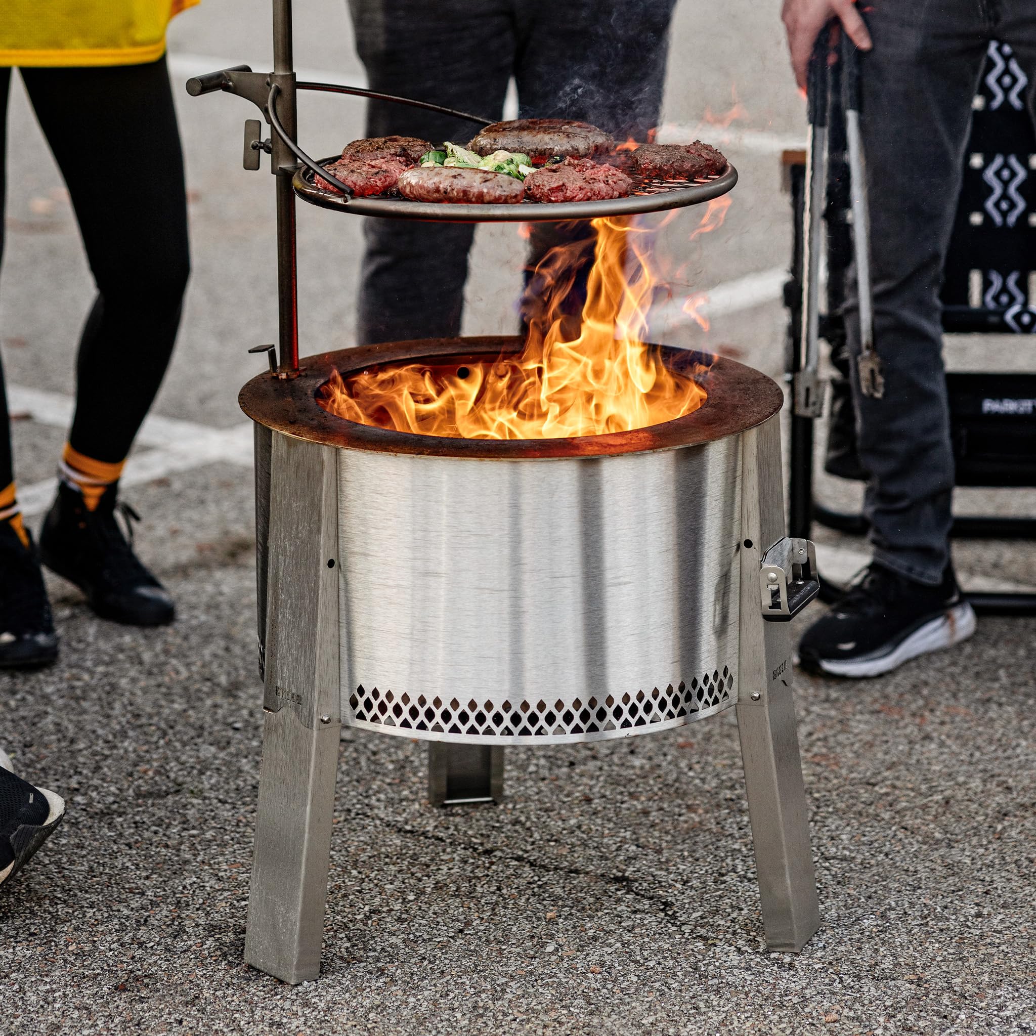 Breeo grill in use over campfire highlighting live-fire cooking and even heat distribution