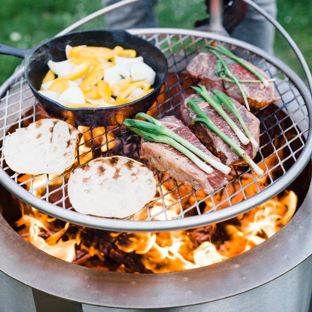 Breeo Outpost Grill 24 rotating over flames demonstrating adjustable heat control