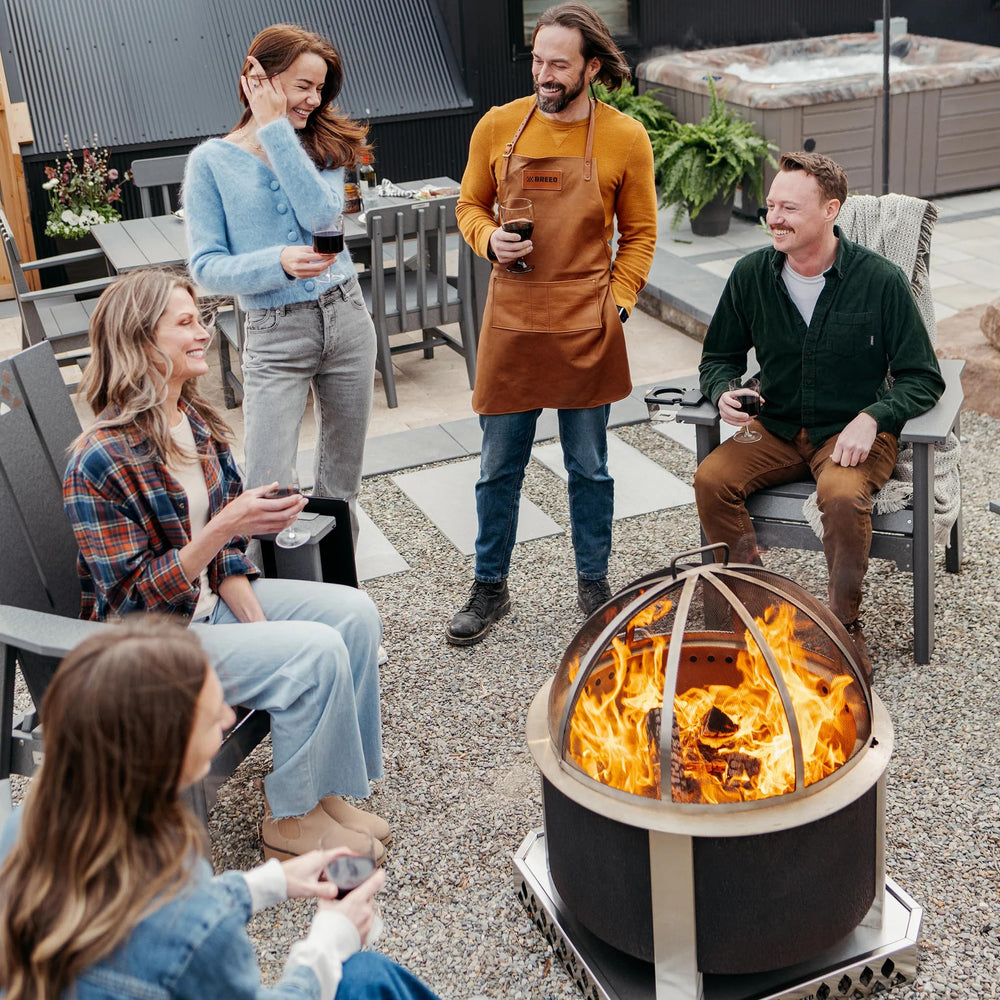 Breeo spark screen in backyard evening setting providing safer fireside ambiance