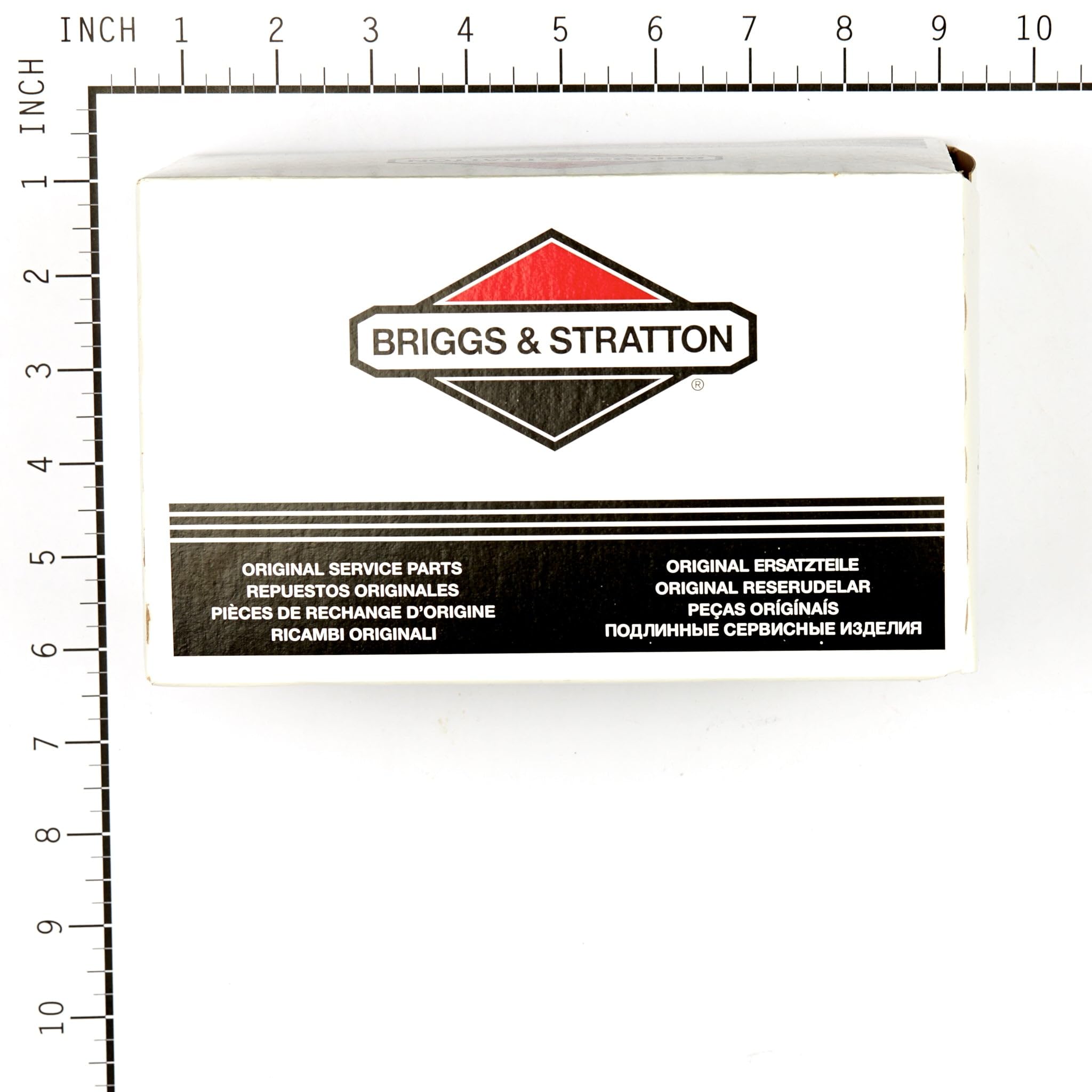 Briggs & Stratton carburetor beside ruler conveying correct size for accurate replacement
