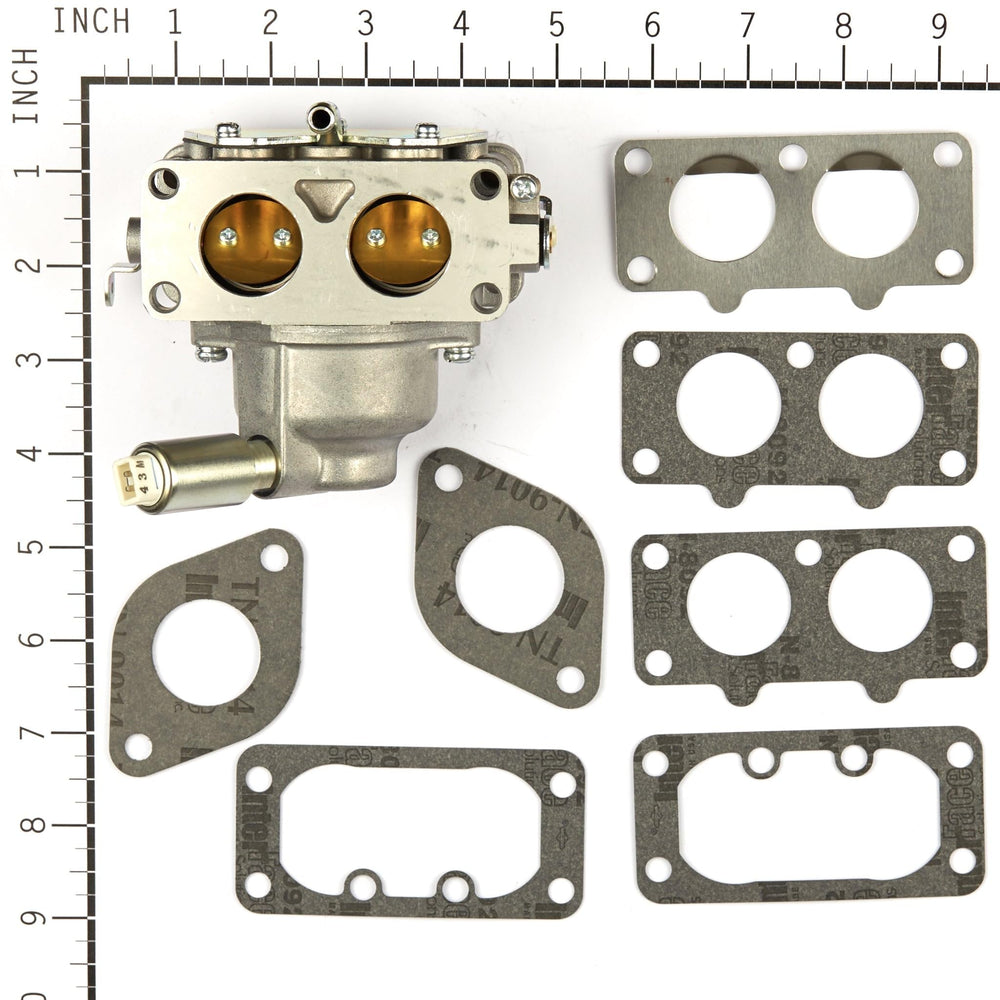 Briggs & Stratton carburetor held in hand to show compact scale and fit