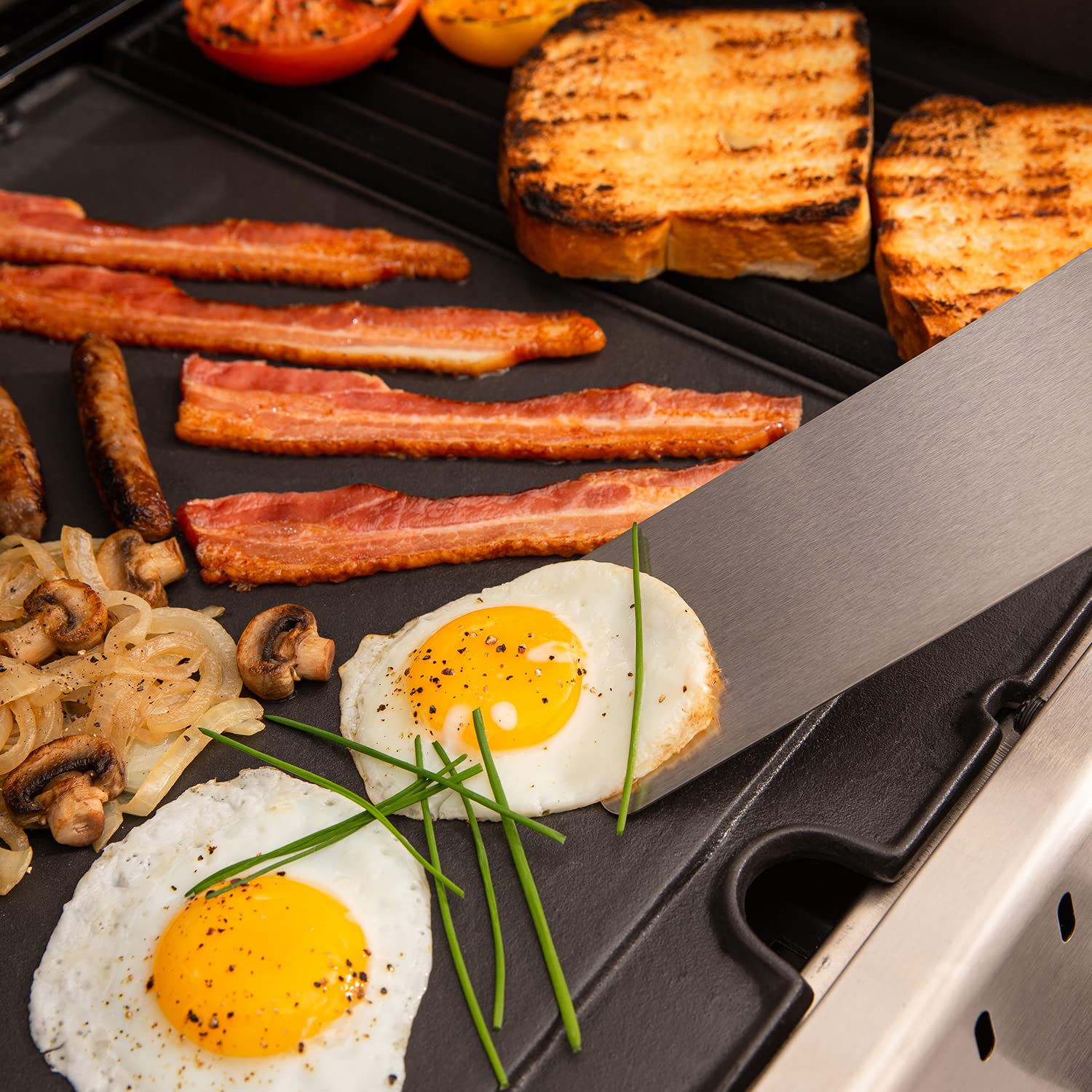 Broil King griddle frying breakfast on grill for easy versatile outdoor meals