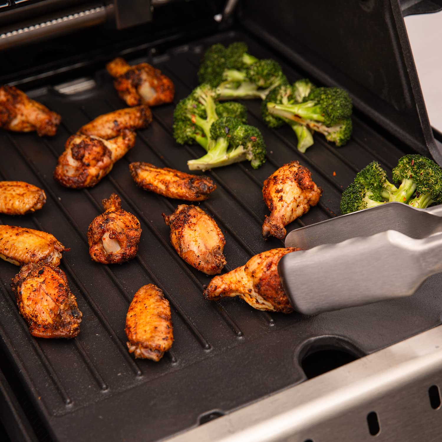 Broil King griddle searing steak on ribbed side for pronounced grill marks