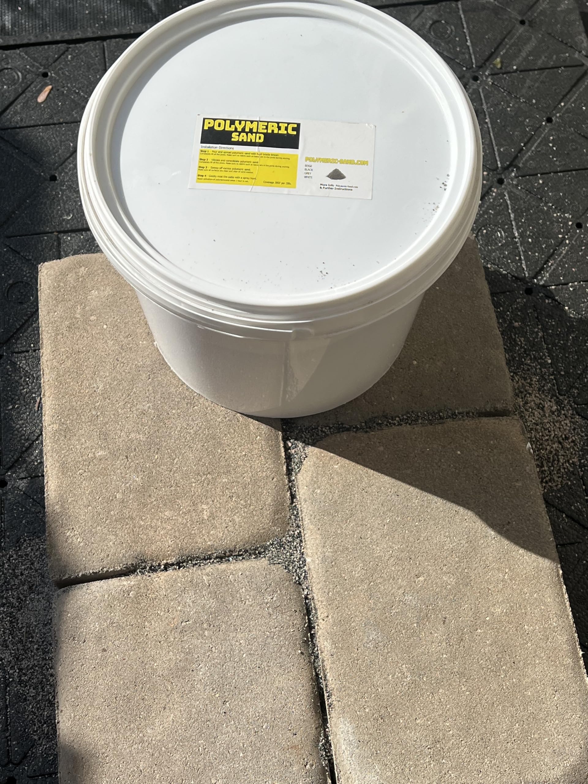 Cured BuddingCo polymeric sand joint between pavers demonstrating durable bonded results