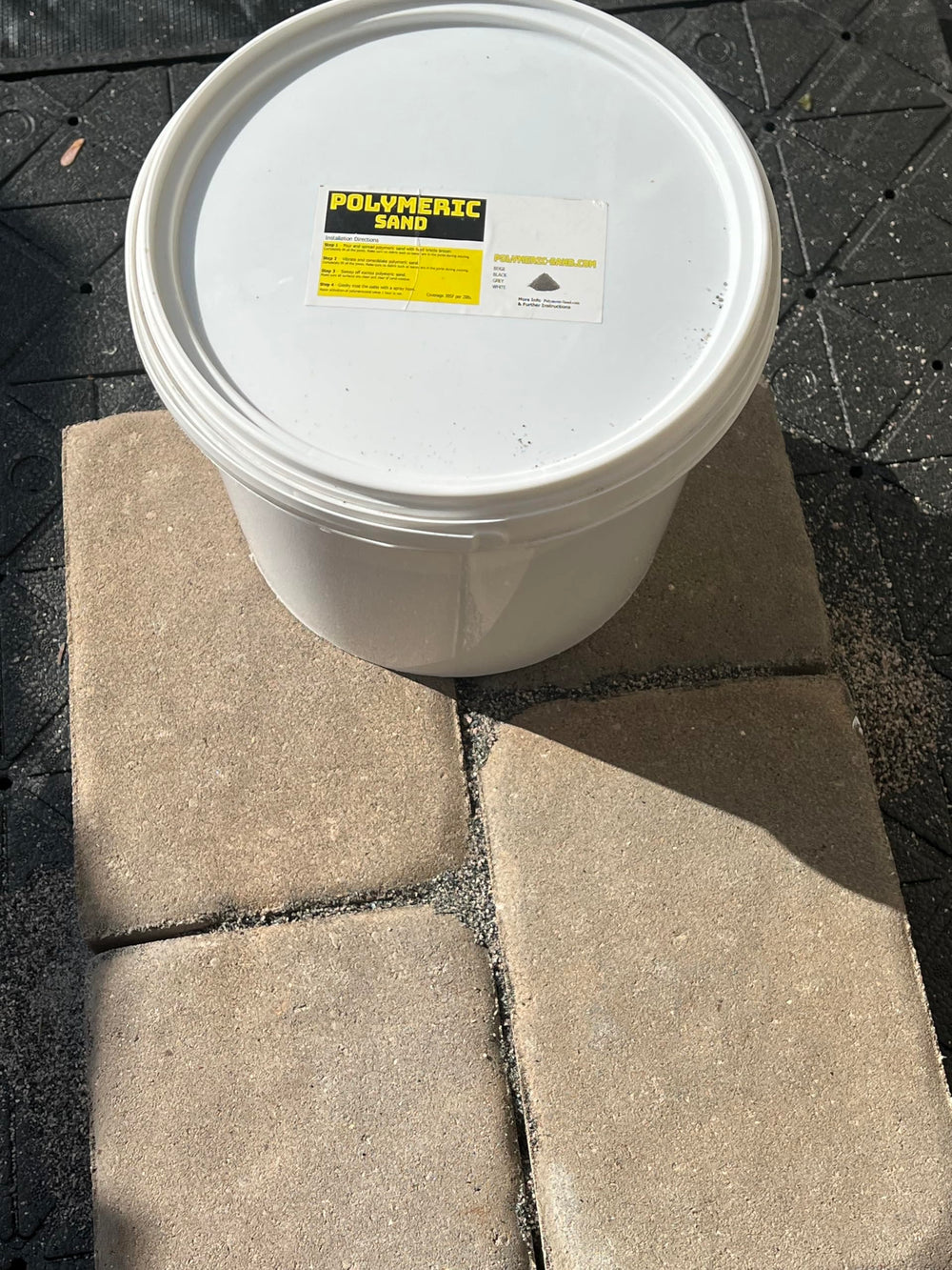Cured BuddingCo polymeric sand joint between pavers demonstrating durable bonded results