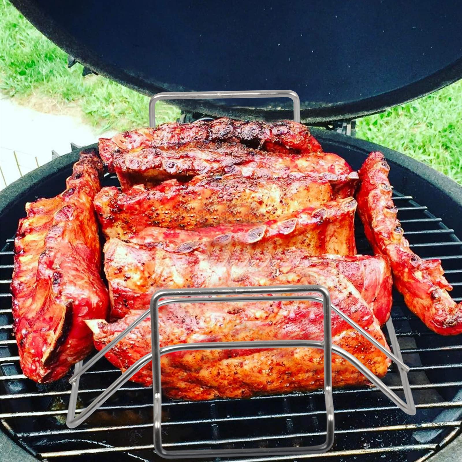Burly grill packed with ribs above a drip pan to prevent flare-ups and collect juices