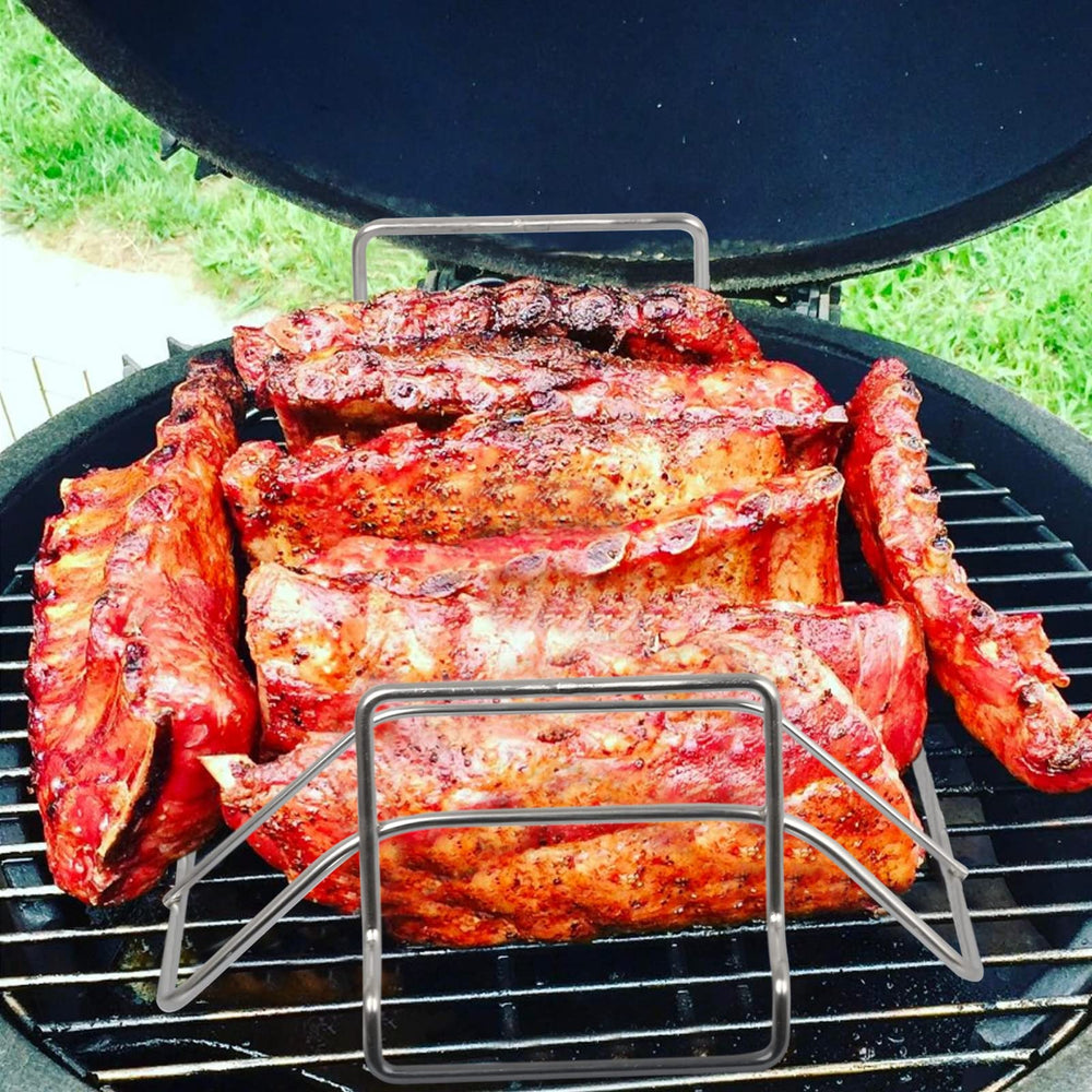 Burly grill packed with ribs above a drip pan to prevent flare-ups and collect juices