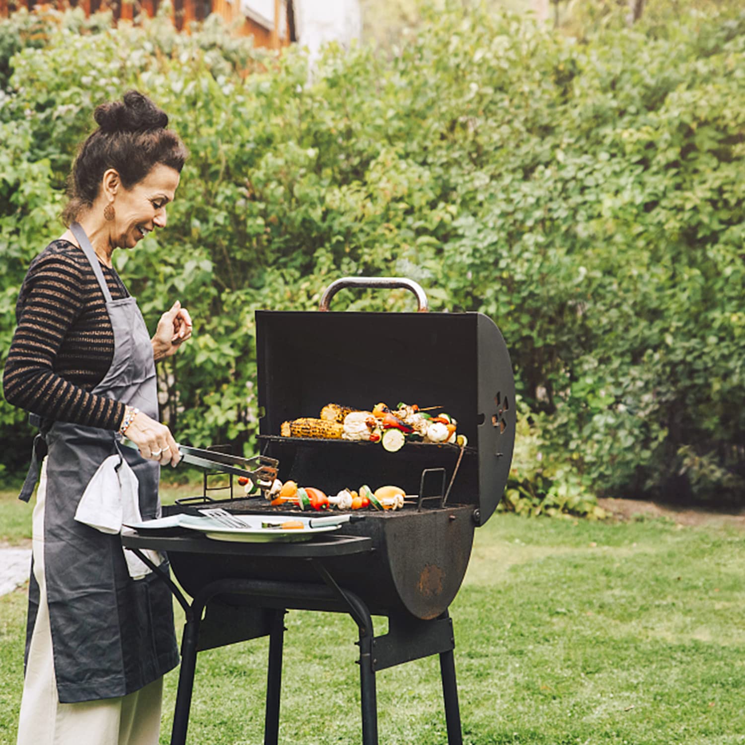 Burly Grill ash pan beside tools for clear size and scale comparison benefit