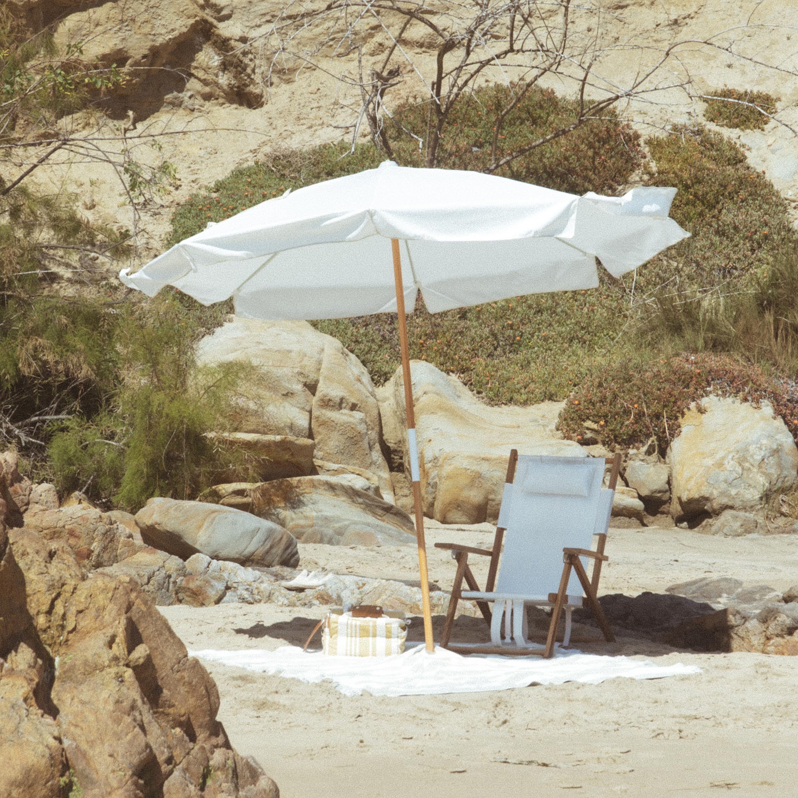 Business & Pleasure Co. umbrella in carry bag showing easy transport and storage benefit