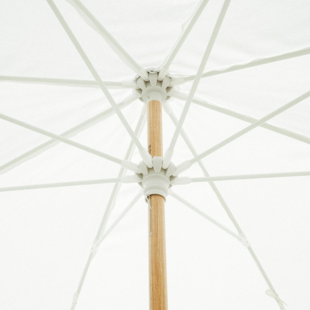 Business & Pleasure Co. umbrella set up on beach showing portability and comfort benefit