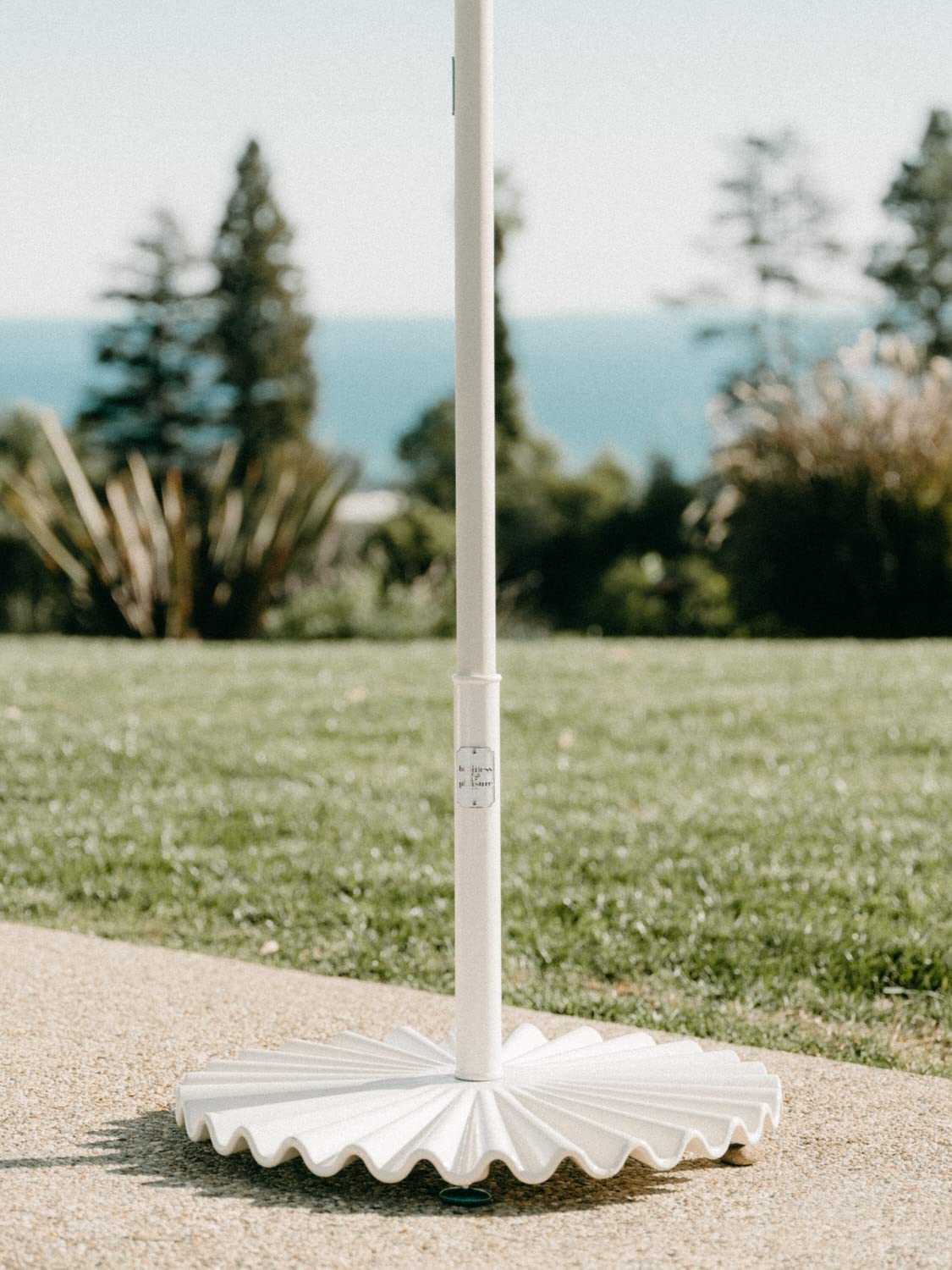 Business & Pleasure Co. base holding umbrella in use showing practical stability and shaded seating