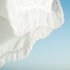 Business & Pleasure Co. Holiday Umbrella in use on sandy beach providing UPF 50+ sun protection
