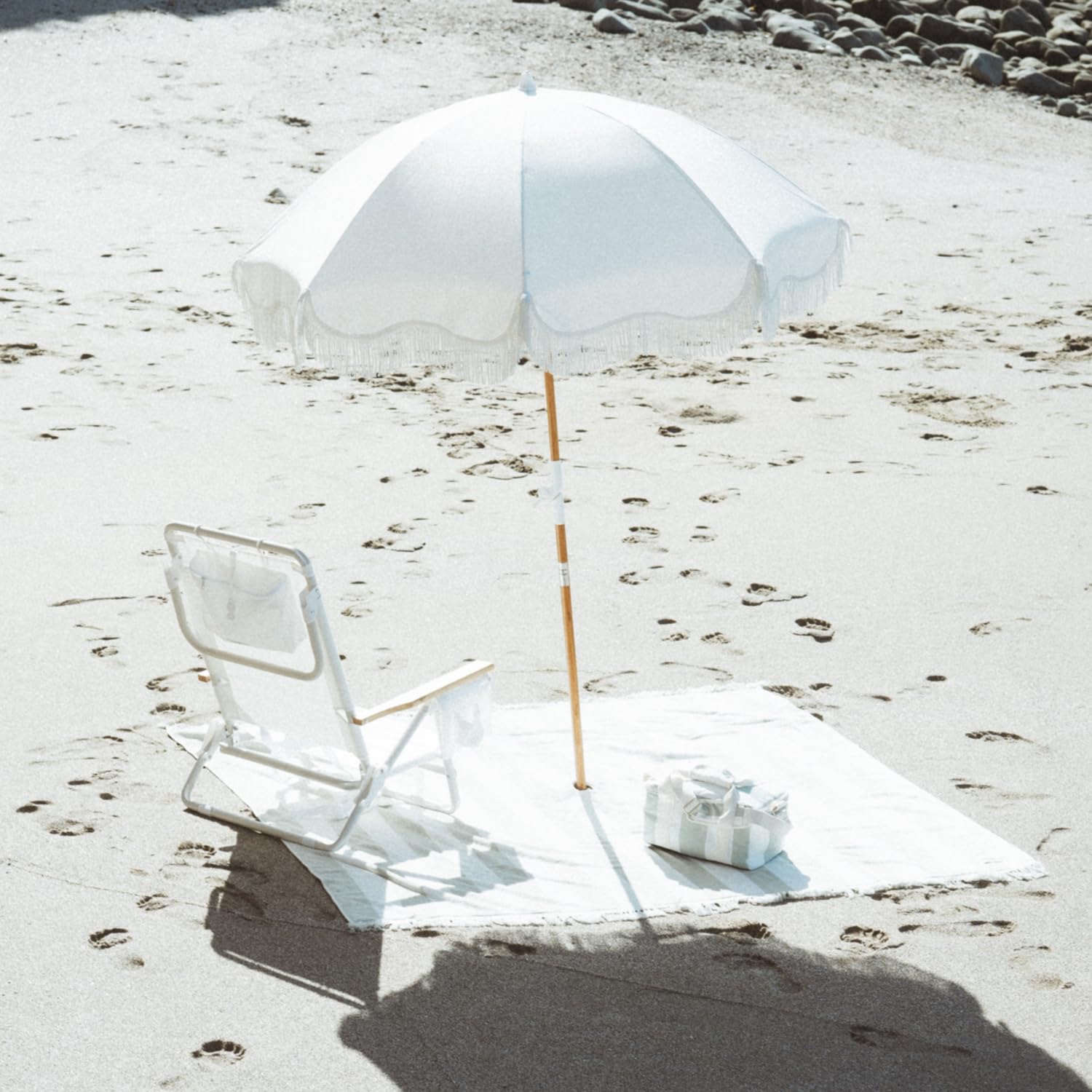 Business & Pleasure Co. Holiday Umbrella folded in carry bag for easy transport and storage