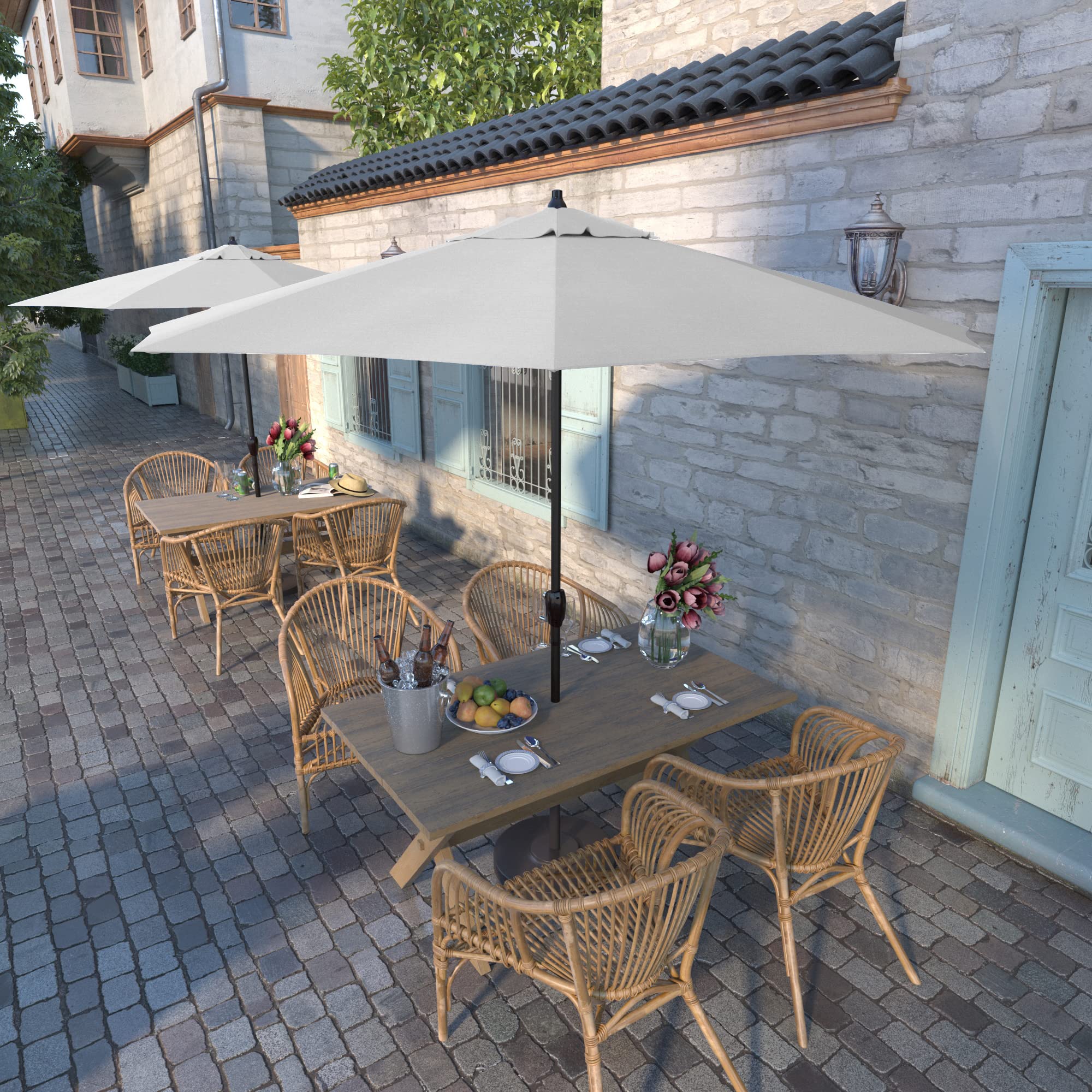 California Umbrella deployed over patio furniture illustrating comfortable shaded outdoor living benefit