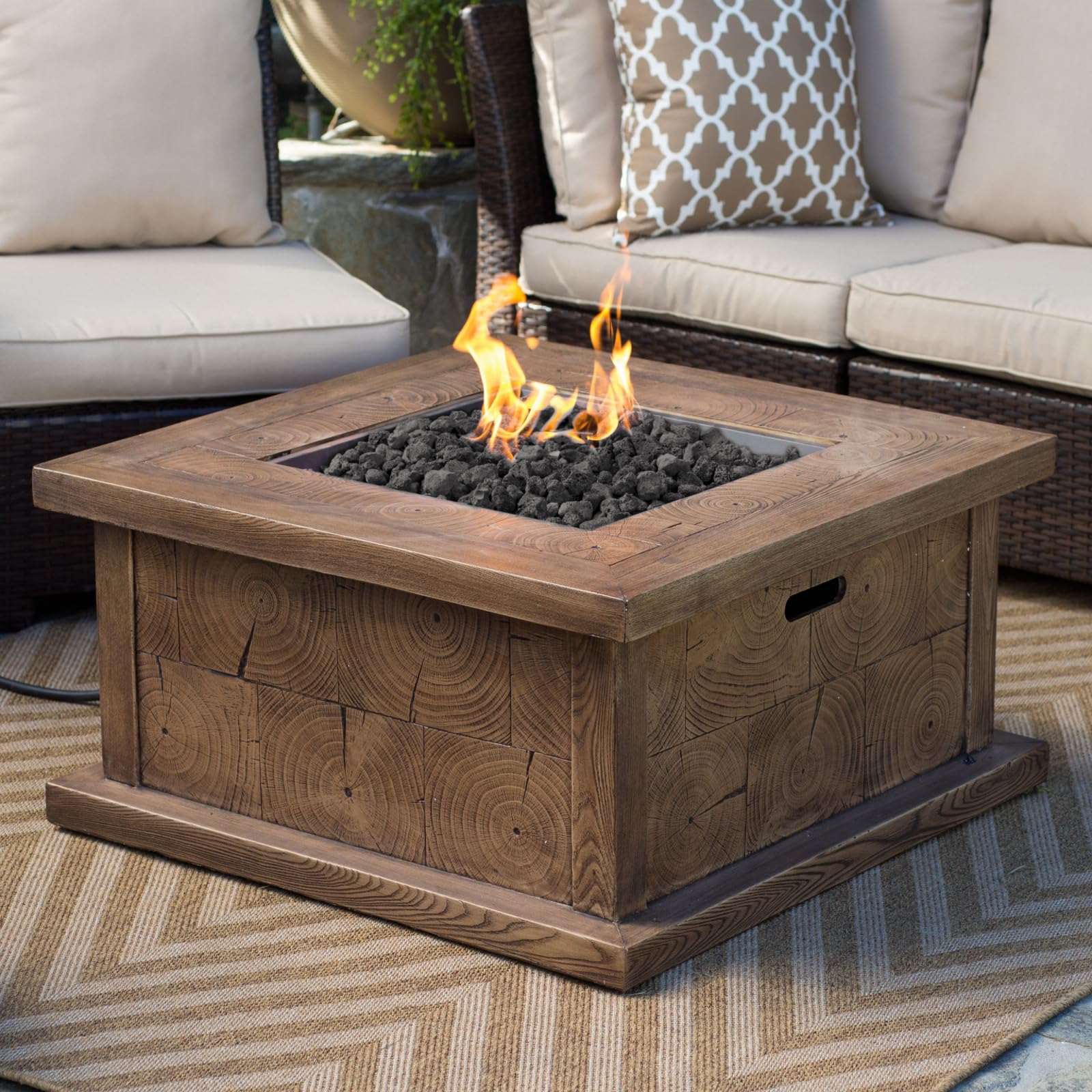 Calofulston lava rock arranged in a fire pit enhancing flame and warmth