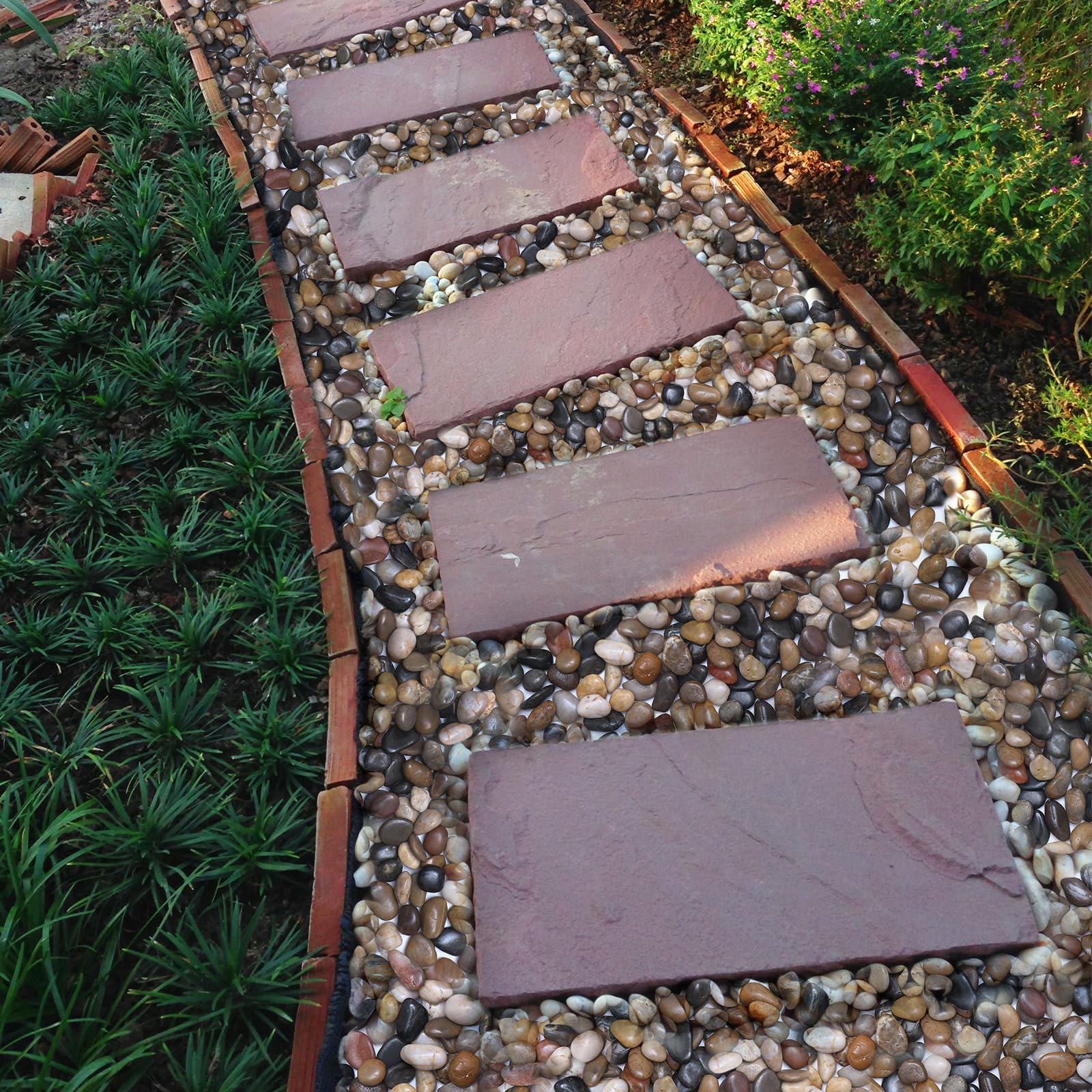 Calofulston stones in garden bed creating low-maintenance landscape