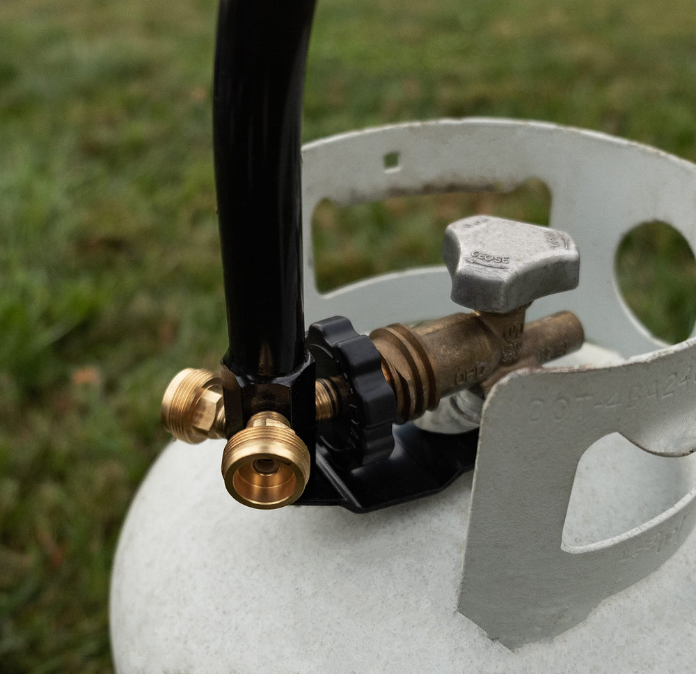 Camco unit attached to 1 lb propane cylinder demonstrating compact setup