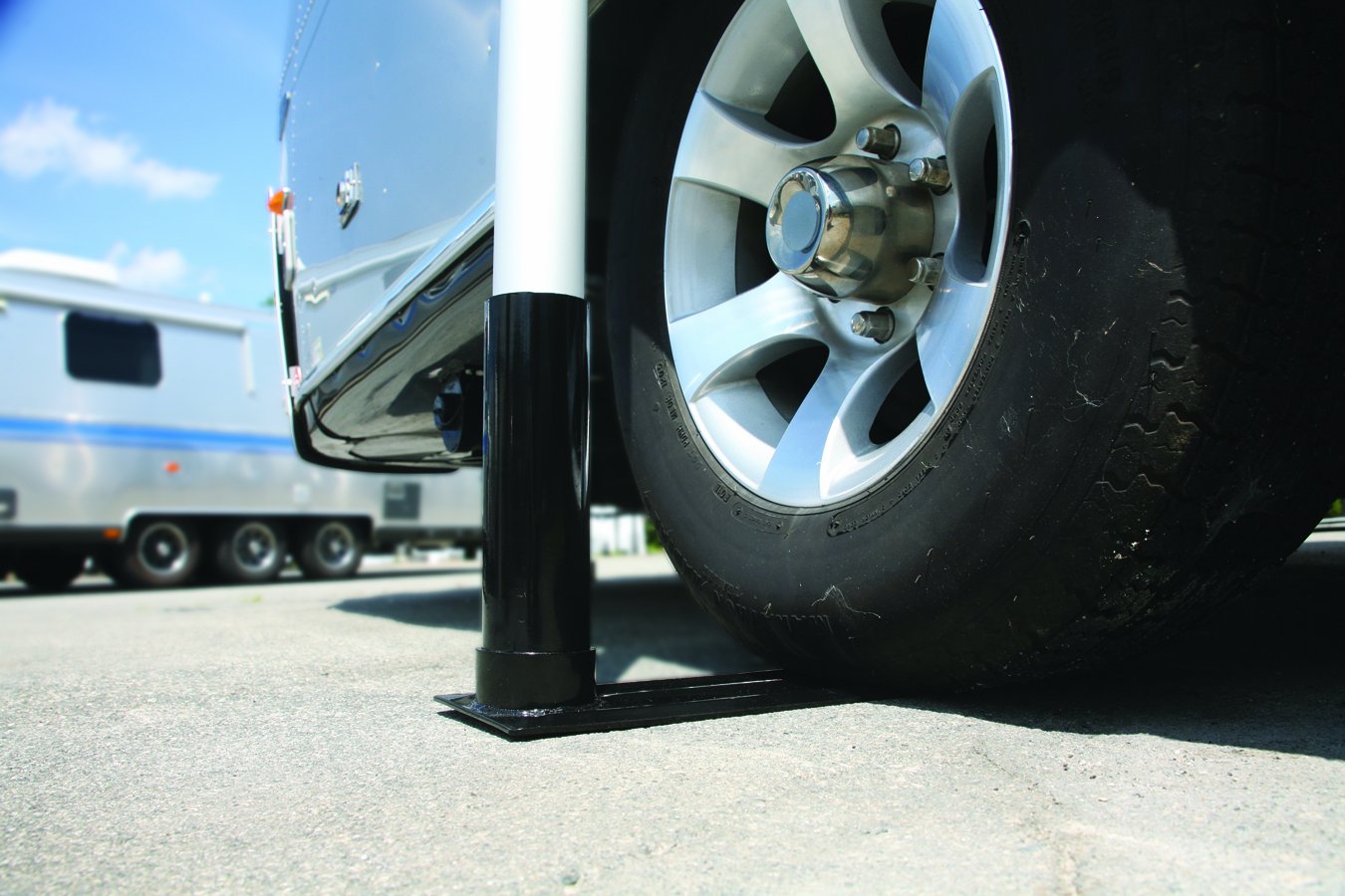 Camco flagpole mounted beside RV showing elevated flag visibility benefit