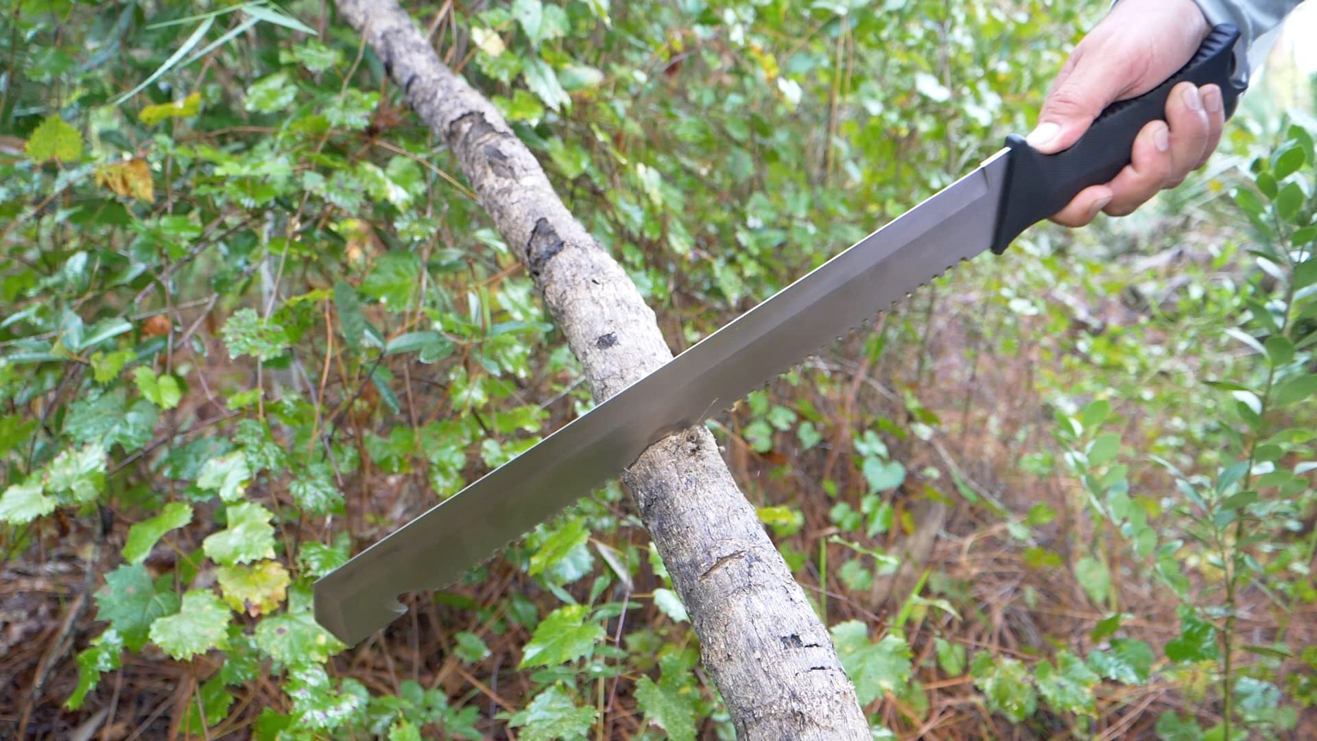 Camillus machete in use at camp showing versatile cutting and saw benefit