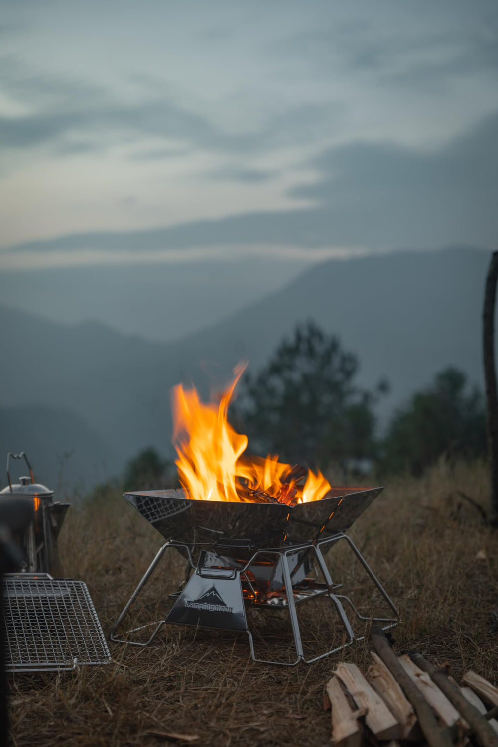 camping moon campsite at dusk showing contained fire and family atmosphere