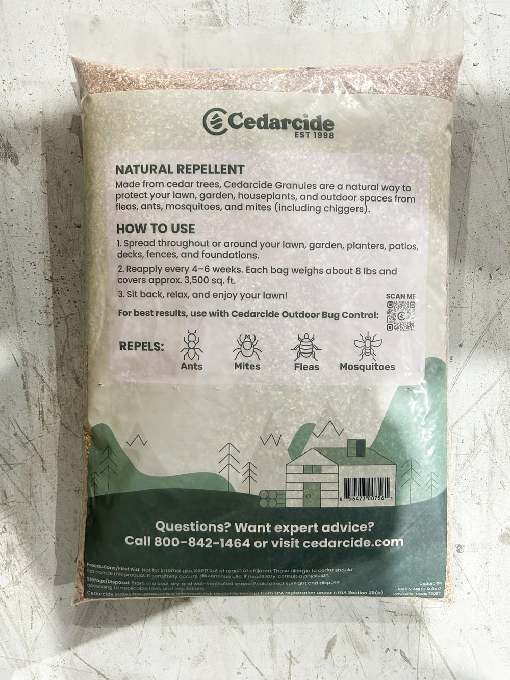 Hand holding Cedarcide granules to show size and texture for easy application understanding