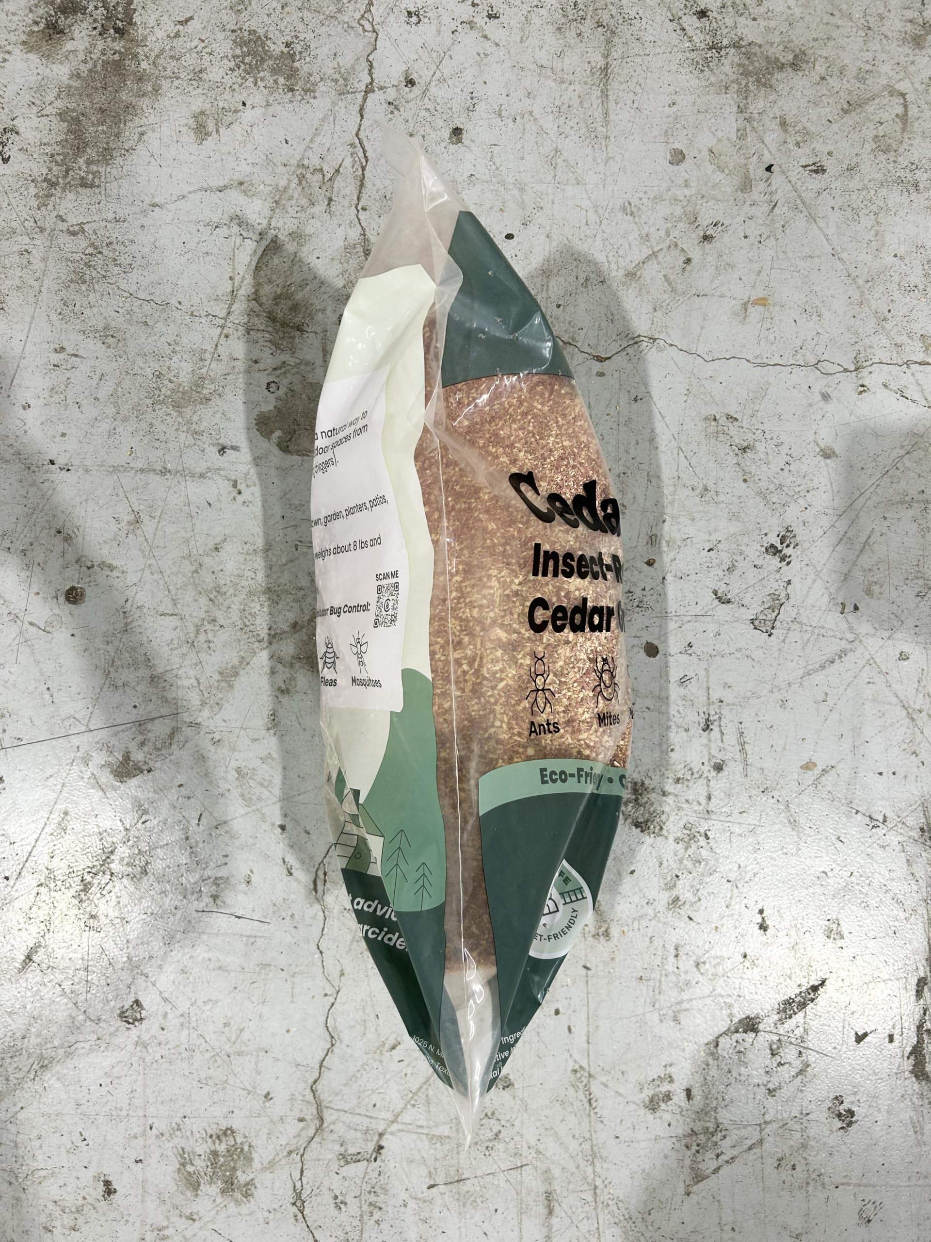 Cedarcide granules beside a ruler demonstrating bag contents scale and coverage estimate