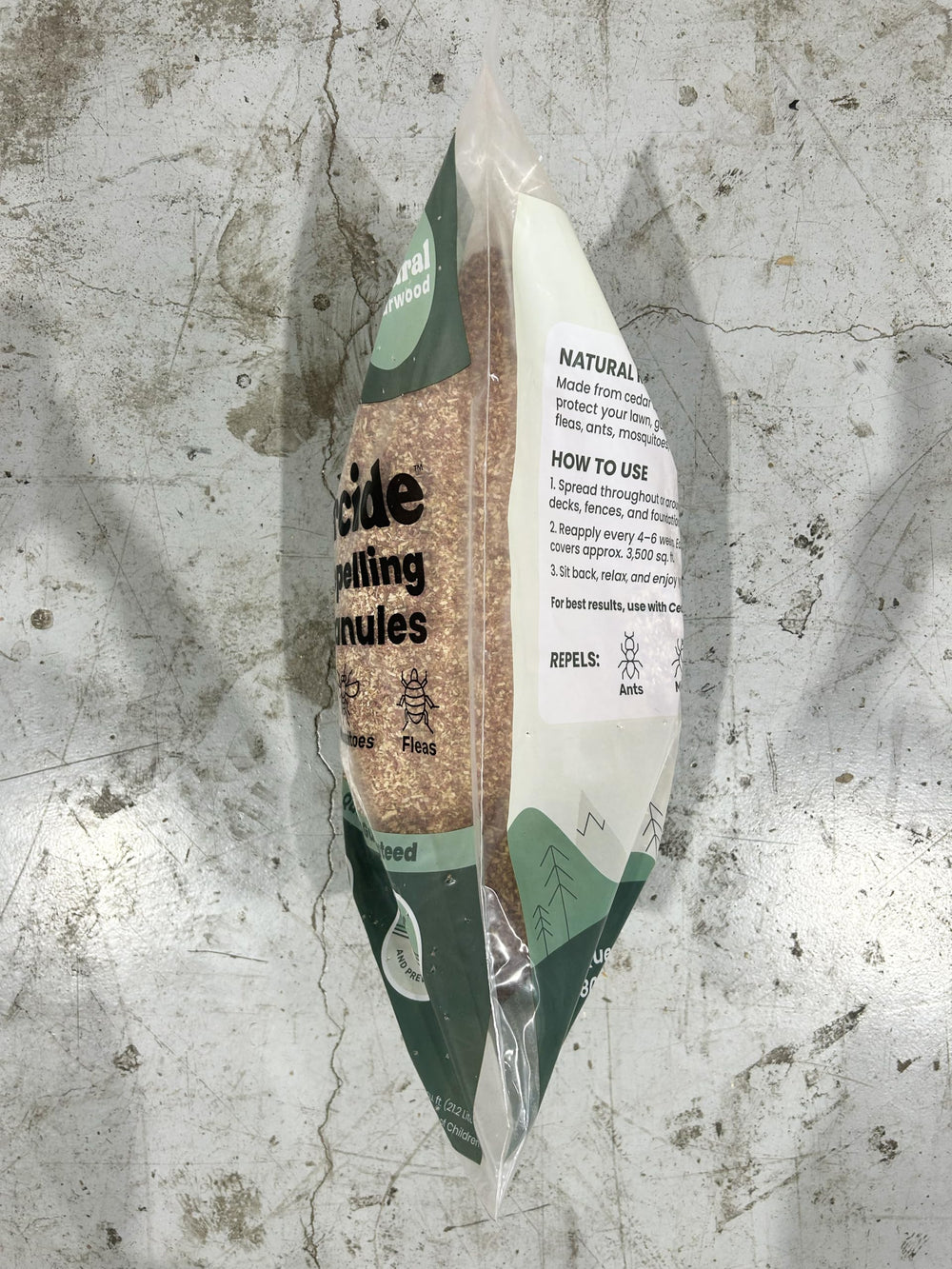 Cedarcide granules placed in a shed corner illustrating odor control and insect deterrence