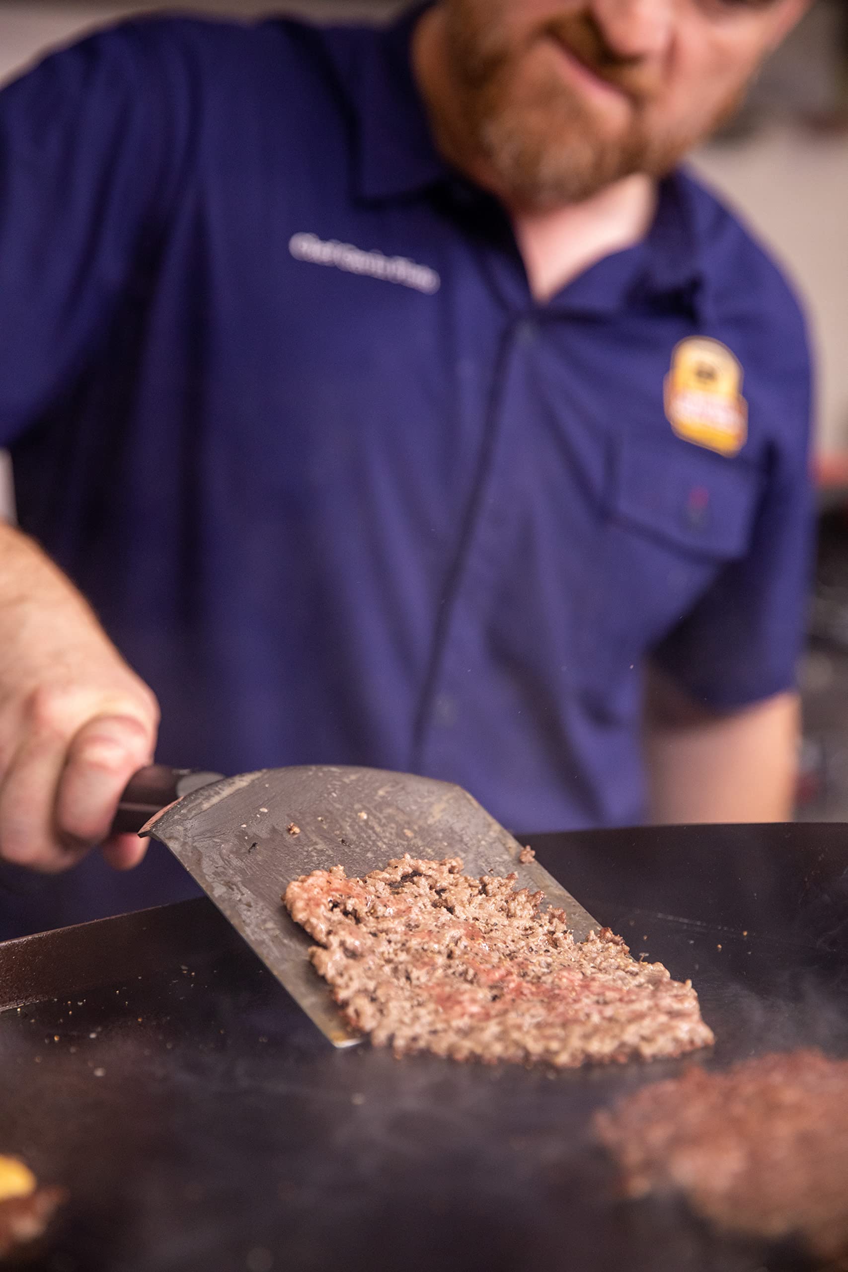 Certified Angus Beef spatula flipping pancakes and eggs showing versatile griddle use