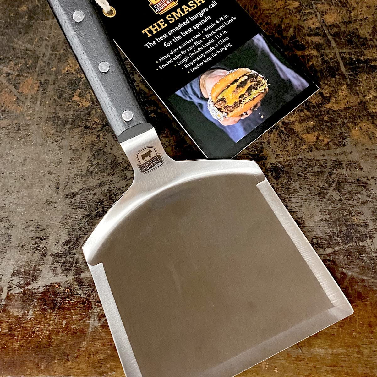 Certified Angus Beef spatula pressing patties on a hot griddle for quick caramelization