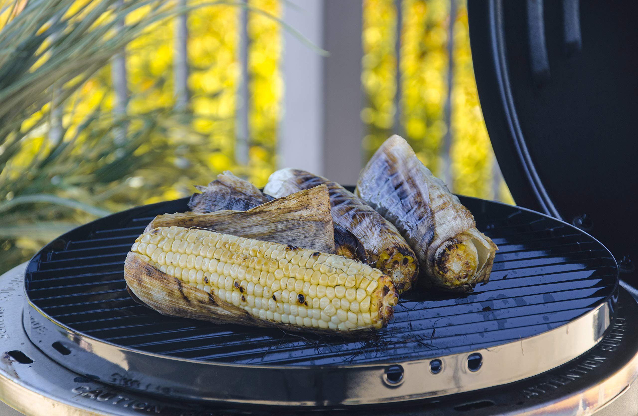 Charbroil Big Easy on a backyard table with served plates showing entertaining benefit