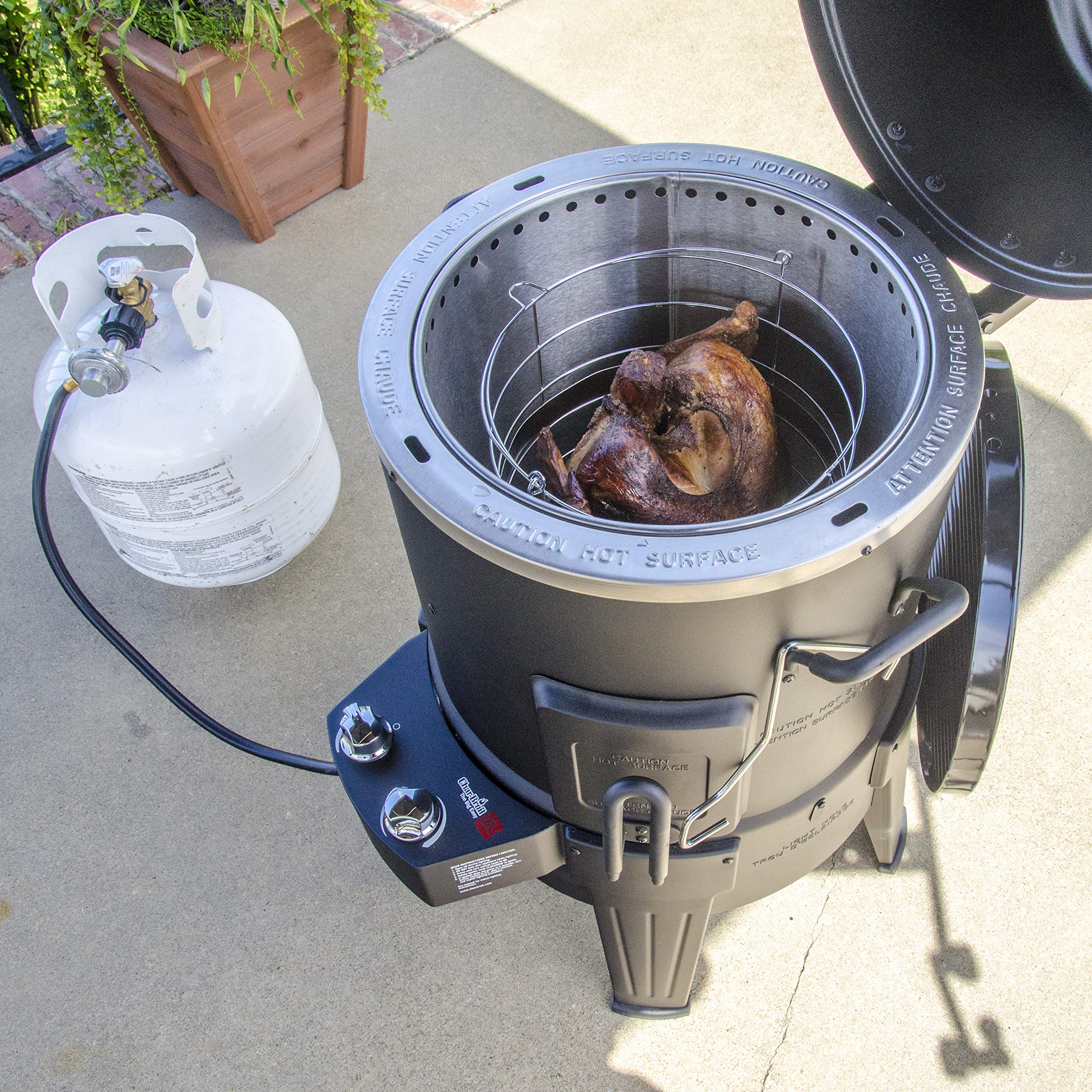 Charbroil Big Easy next to a turkey for scale showing family-size cooking benefit