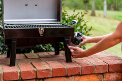 Charbroil in use at beach picnic demonstrating portable grilling convenience