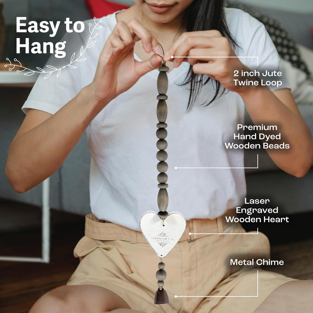 Cherish Gift Co. wind chime hanging on a porch creating gentle comforting sounds