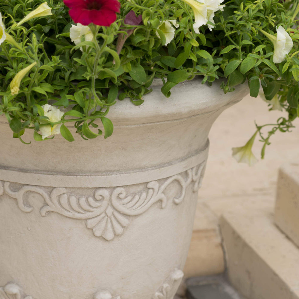 Christopher Knight Home urn beside lounge chair showing true 20-inch scale and placement benefit