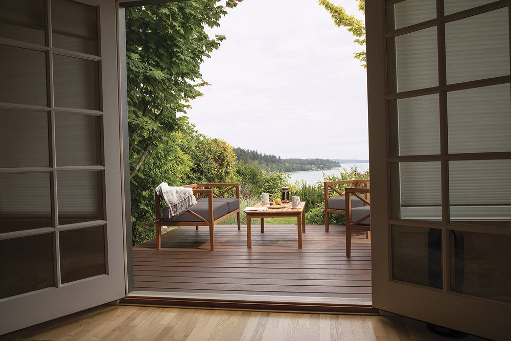 Classic Accessories Ravenna placed on a patio loveseat showing weather-ready style and comfort benefit