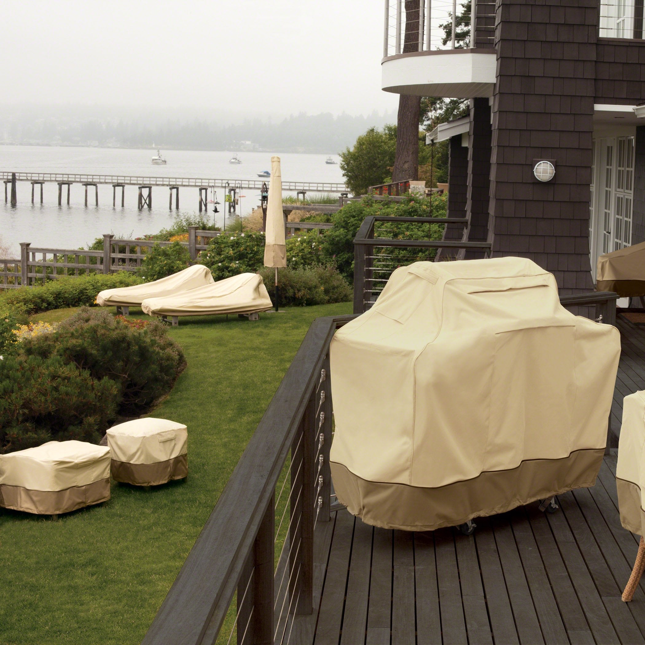 Classic Accessories cover fitted over oval table in backyard protecting set