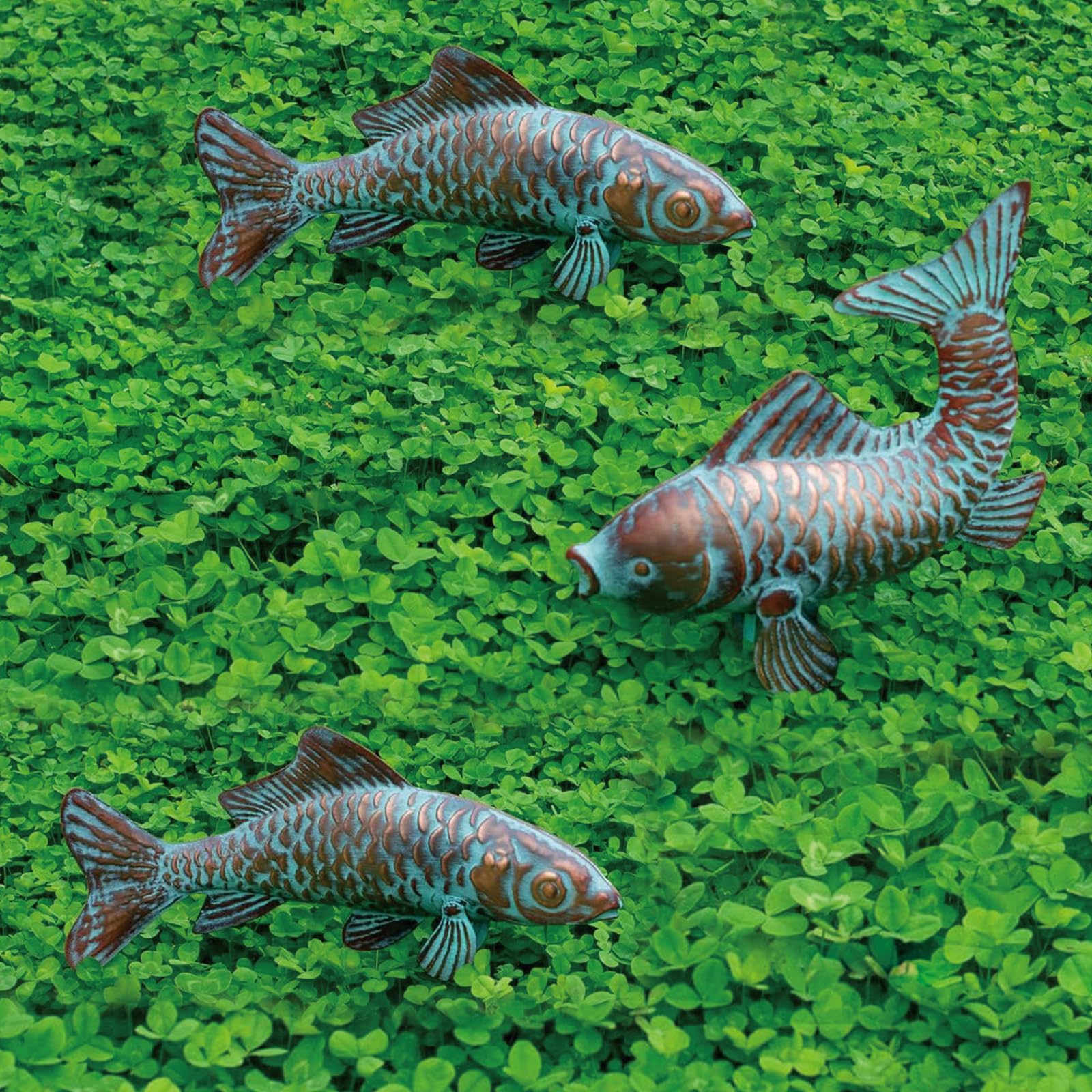 CLYB front view of three koi statues, shows elegant garden focal point