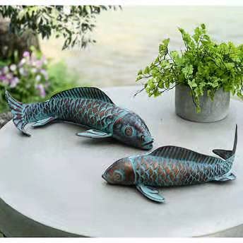 CLYB koi sculptures beside a potted plant to show scale and placement ideas