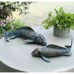 CLYB koi sculptures beside a potted plant to show scale and placement ideas