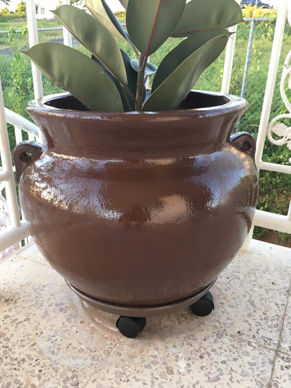 Coadura plant caddy holding a planter on a patio showcasing outdoor durability