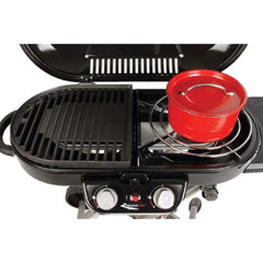 Coleman grate next to a 12-inch pan showing scale and packing convenience benefit