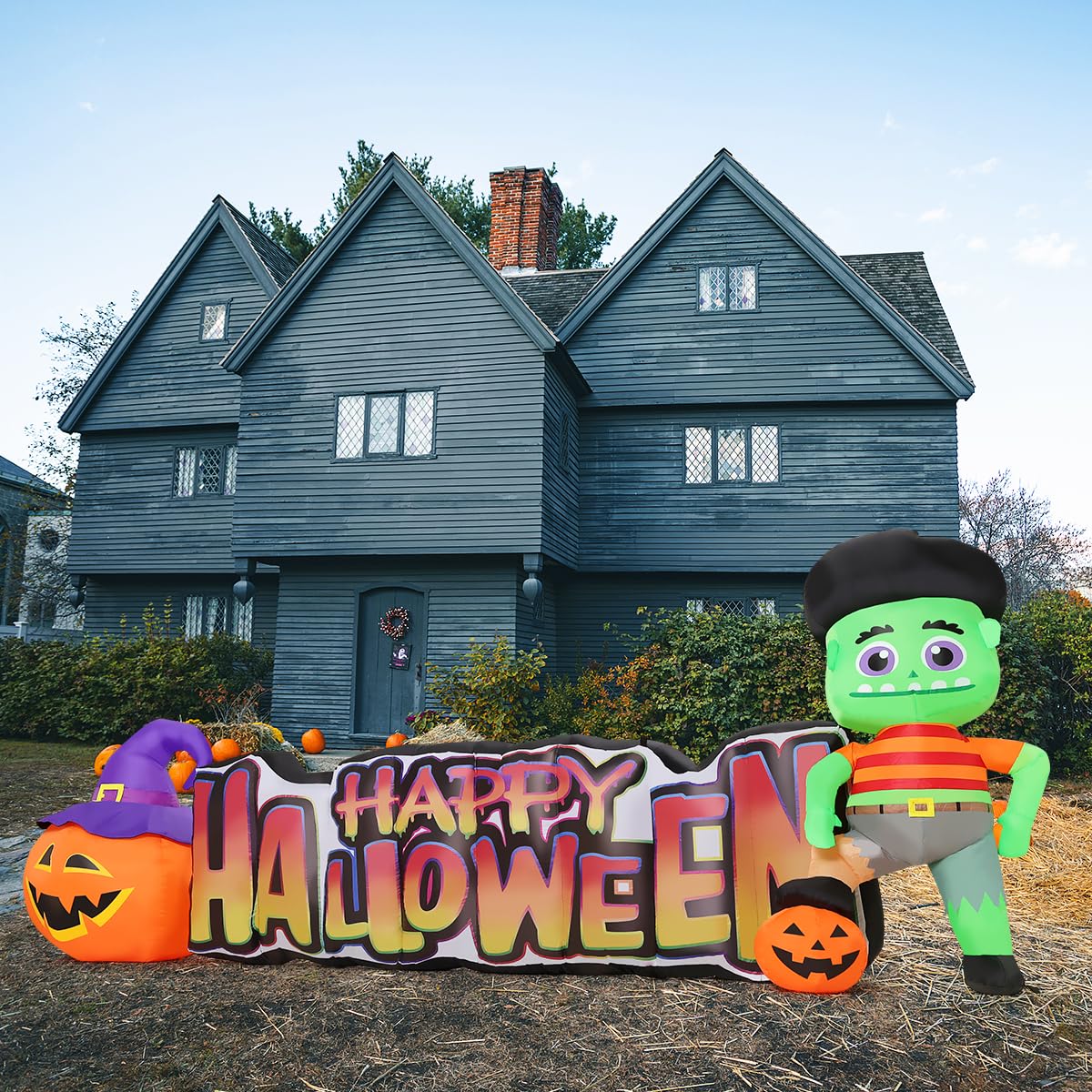COMIN inflatable next to house for scale highlights 11-foot tall presence